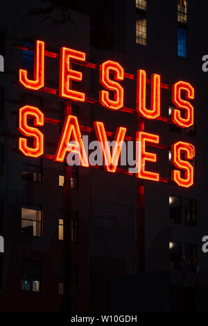 Jesus Saves sign at night, in downtown Los Angeles, California Stock Photo