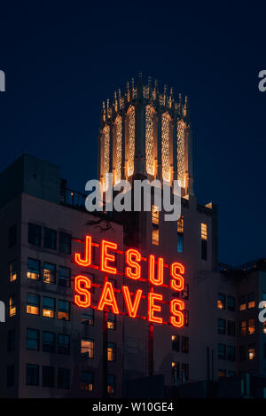 Jesus Saves sign at night, in downtown Los Angeles, California Stock Photo