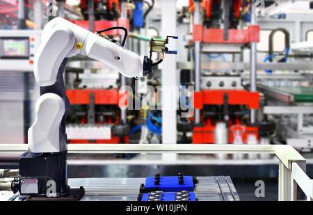 Robot arm machine for Automotive bearings packing process in factory. Stock Photo