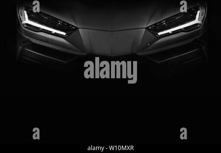 Silhouette of black sports car with LED headlights on black background,copy space Stock Photo