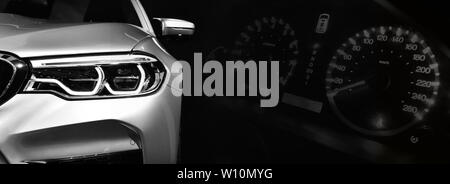 Gray modern car headlights on car instrument panel background