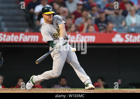 Anaheim, California, USA. 28th June 2019. Oakland Athletics third baseman Matt Chapman (26) makes contact at the plate during the game between the Oakland A's and the Los Angeles Angels of Anaheim at Angel Stadium in Anaheim, CA, (Photo by Peter Joneleit, Cal Sport Media) Credit: Cal Sport Media/Alamy Live News Stock Photo