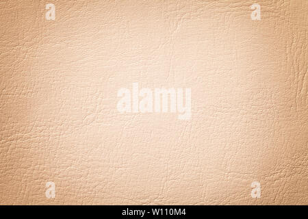 Light coral leather texture background, closeup. Beige cracked backdrop from wrinkle skin, structure of textile with vignette. Stock Photo