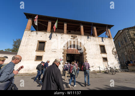 Ancient palace, a tourist information point in downtown of Lucca, Tuscany, Italy, Europe. Group of tourists is entering to ask about the city Stock Photo