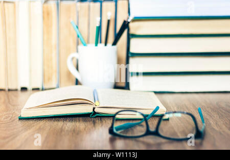 Stack of books, pencils, open book, glasses, background for education learning concept Stock Photo