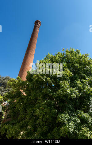 Ancient smokestack made of bricks in downtown of Lucca, Tuscany, Italy, Europe Stock Photo