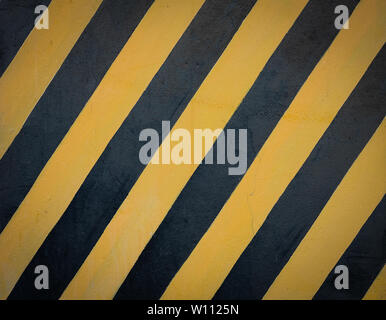 Striped black and yellow grunge background, warning signage. Stock Photo
