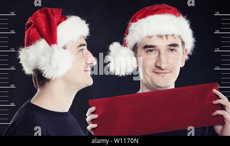 man in Santa Claus hat posing in a prison. Concept santa search Stock Photo