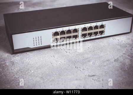 Fast Gigabit Ethernet Switch 16 Port on Dark Background Stock Photo