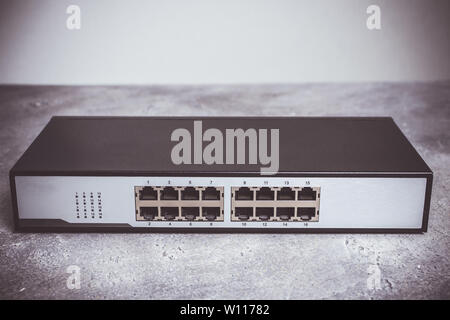 Fast Gigabit Ethernet Switch 16 Port on Dark Background Stock Photo