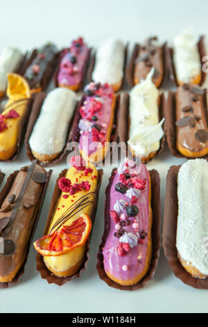 Set of several eclairs with various fillings and design isolate on a white background, the concept of French cuisine, copyspace Stock Photo