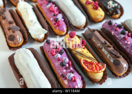 Set of several eclairs with various fillings and design isolate on a white background, the concept of French cuisine, copyspace Stock Photo