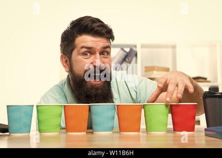 Pick one. Diversity and recycling. Eco paper cup. Coffee to go paper cup. How many cups per day. Choose from alternatives. Man bearded choosing one of lot colorful paper cups. Alternative concept. Stock Photo