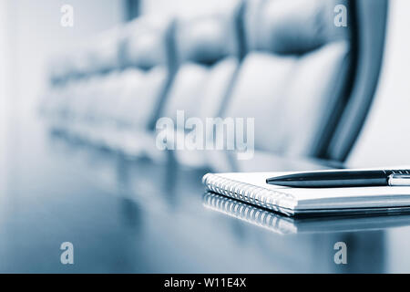 Closeup of notepad kept on table in empty room Stock Photo