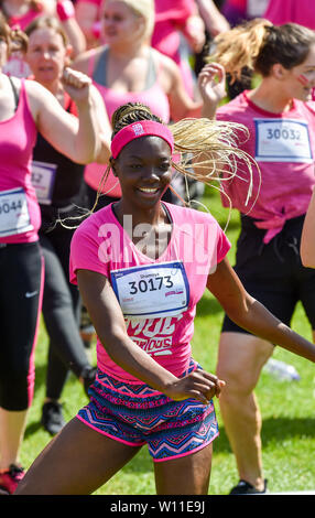 Brighton UK 29th June 2019 - Over a thousand take part in hot sunny heatwave conditions in the Cancer Research UK Pretty Muddy event in Stanmer Park Brighton . Participants run an obstacle course with mud baths included en route raising money for the charity on what is predicted to be the hottest day of the year so far . Credit: Simon Dack / Alamy Live News Stock Photo