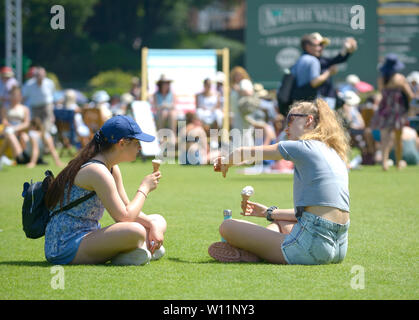 Two girls eat ice cream, Devonshire Park, Eastbourne, UK. 29th June, 2019. Perfect weather for watching the tennis, if perhaps a bit warm to be playing - at Nature Valley International tennis Stock Photo