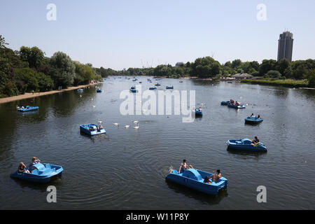 Visitors to Hyde Park, London, ride pedalos on the Serpentine. Stock Photo