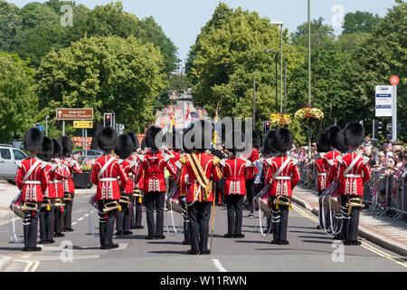 The Grenadier Guards parade around Aldershot town in Hampshire, UK, in celebration of Armed Forces Day, 29 June 2019. The Grenadier Guards are one of the oldest regiments in the British Army, specialising in light infantry, and are famous for their red tunics and bearskins. Stock Photo
