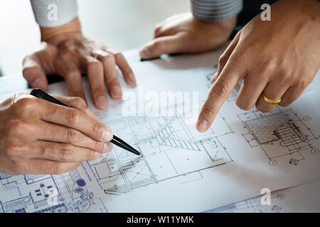 Real-estate concept, Two engineer and architect discussing blueprints data working and digital tablet on construction building project. Stock Photo