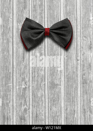 Black and red bow tie on a light wooden background Stock Photo