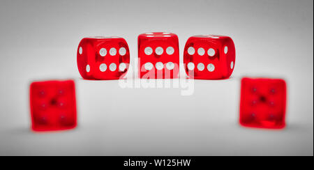 Red dice on a grey background with selective focus and shallow depth of field. Stock Photo