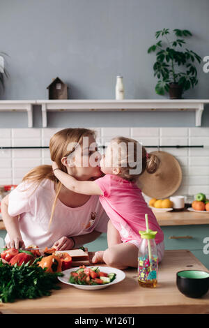 Mother cooking dinner on kitchen with her little cute kid Stock Photo -  Alamy