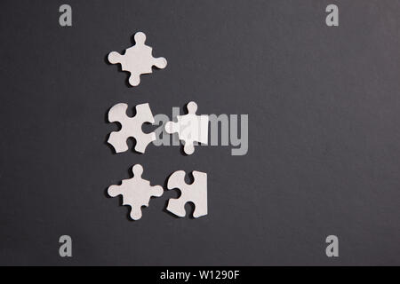 Pieces of a jigsaw puzzle yet to be put together or connected Stock Photo