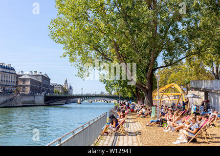 Paris, France - September 2, 2018: people from Paris enjoying a hot summer day at the Seine River margins Stock Photo