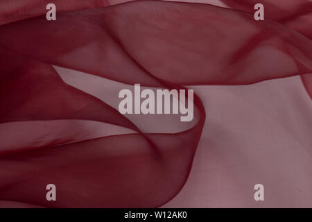 Beautiful close up of red silk fabric with textile texture background Stock Photo
