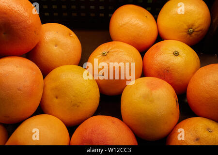 Grapefruit in a basket on the counter of a vegetable store. Stock Photo