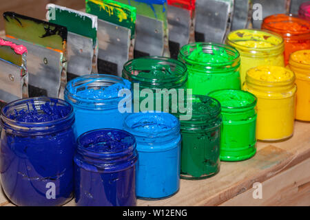 several colors plastisol ink cans in factory who use plastisol ink to print  tee shirt and print on fabric. Plastisol ink useful in tee shirt factory  Stock Photo - Alamy