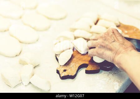 Preparing, cooking, making homemade fried patties or pies with potato and beans Stock Photo