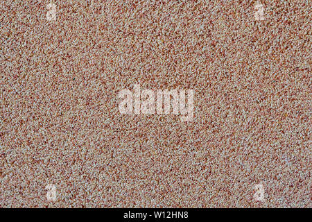 Against the background of disseminated sand small gravel, a stone crumb. Texture of a surface of a wall,light color Stock Photo