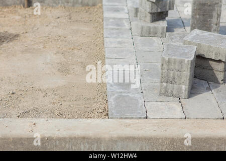 Construction of pavement details, cobblestone pavement, stone blocks on road construction site Stock Photo