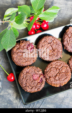 Fruit cake with sour cherries on black plate Stock Photo
