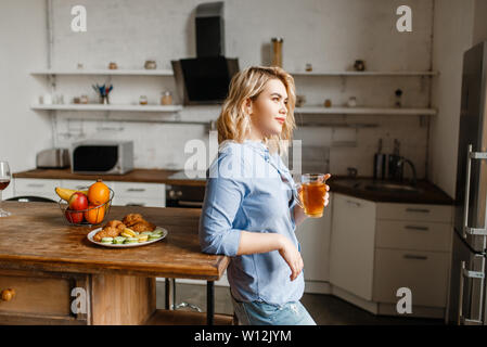 Woman having breakfast with croissants and cookies Stock Photo