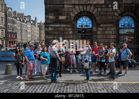 A walking tour on the corner of Parliament Square and High Street, Edinburgh, Scotland, UK. Stock Photo