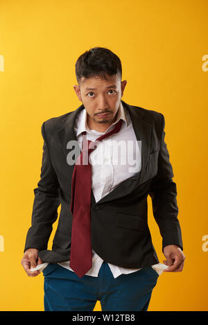 Asian sad guy without money in pockets Stock Photo