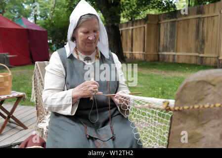 Turku, Finland. 29th June, 2019. A handicraftswoman shows an ancient way to weave a fishing net in Turku, southwestern Finland, on June 29, 2019. The annual Medieval Market, one of the largest historical events in Finland, is held in Turku from June 27 to June 30. Modern people can enjoy ancient music and dance, historical street plays, traditional food and handicrafts during the event. Credit: Zhang Xuan/Xinhua/Alamy Live News Stock Photo