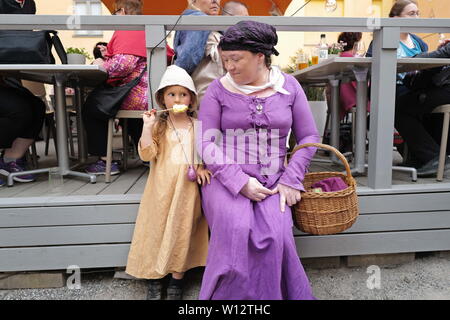 Turku, Finland. 29th June, 2019. A woman and a girl in medieval costumes are seen in Turku, southwestern Finland, on June 29, 2019. The annual Medieval Market, one of the largest historical events in Finland, is held in Turku from June 27 to June 30. Modern people can enjoy ancient music and dance, historical street plays, traditional food and handicrafts during the event. Credit: Zhang Xuan/Xinhua/Alamy Live News Stock Photo