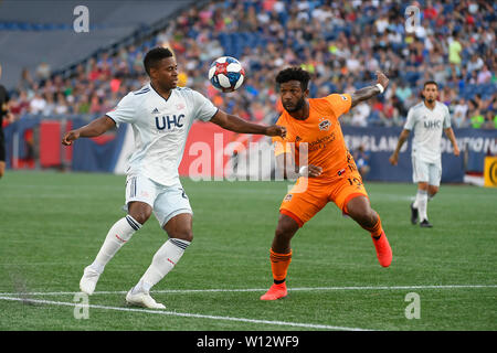 Foxborough Massachusetts, USA. 29th June, 2019. Houston Dynamo forward Michael Salazar (19) (orange) and New England Revolution forward DeJuan Jones (24) (white) in game action during the MLS game between the Houston Dynamo and the New England Revolution held at Gillette Stadium in Foxborough Massachusetts. Eric Canha/CSM/Alamy Live News Stock Photo