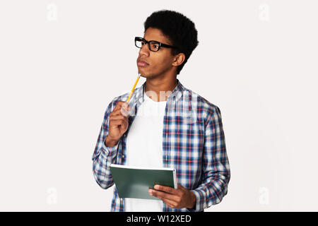 African-American Thoughtful Nerd Thinking about Test in Studio Stock Photo