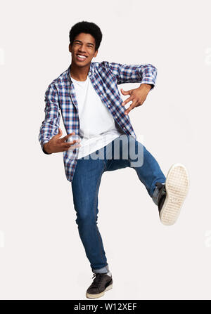 Just Having Fun. Excited Guy Jumping Against White Background Stock Photo