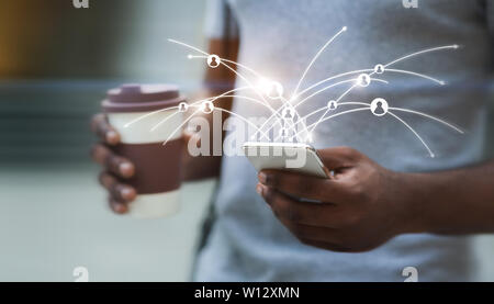 African guy using cellphone with virtual diagram of network connection Stock Photo
