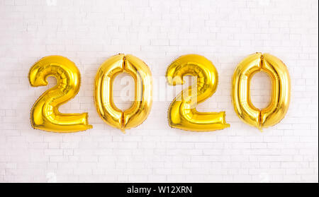 Gold Party balloons in 2020 numbers shape on white background Stock Photo