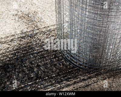 Roll loose shiny thin steel wire grating Stock Photo