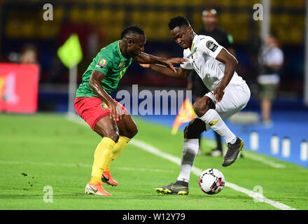 Ismailia, Egypt. 29th June, 2019. Ethiopian referee Bamlak Tessema Weyesa  (2nd L) shows a yellow card to Ghana's defender Kassim Adams Nuhu during  the 2019 Africa Cup of Nations Group F match