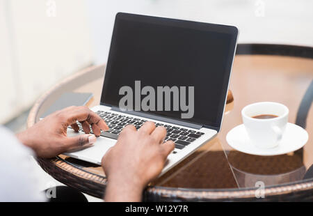 Unrecognizable african american man using laptop with blank Stock Photo