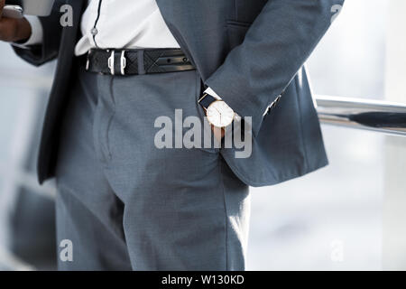 Man Hand with Wrist Watch in the Pocket of Stylish Pants Stock Photo