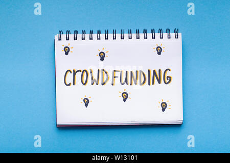 Handwriting red text in notepad on blue background Stock Photo
